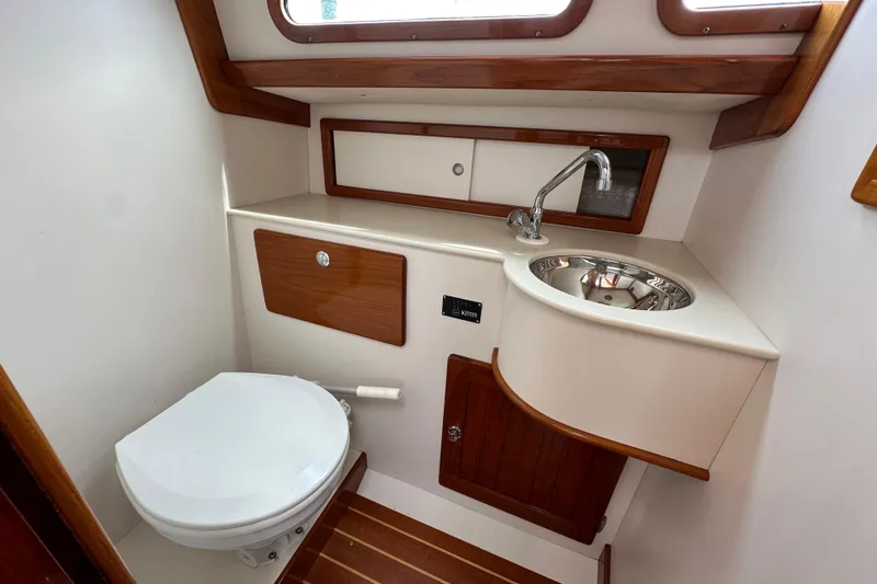 Slide: The Image of Compact bathroom in 2006 Morris M36 yacht with sink, toilet, and wooden accents. - 20