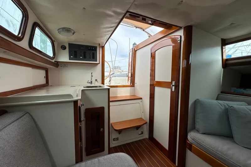 Slide: The Image of Interior of 2006 Morris M36 sailboat with wooden accents and cozy seating. - 21