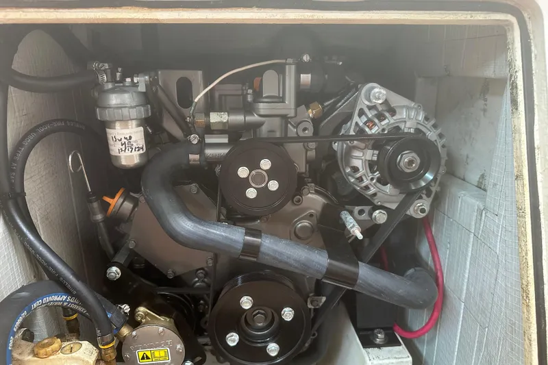 Slide: The Image of Engine compartment of a 2006 Morris M36, showcasing belts and components. - 22