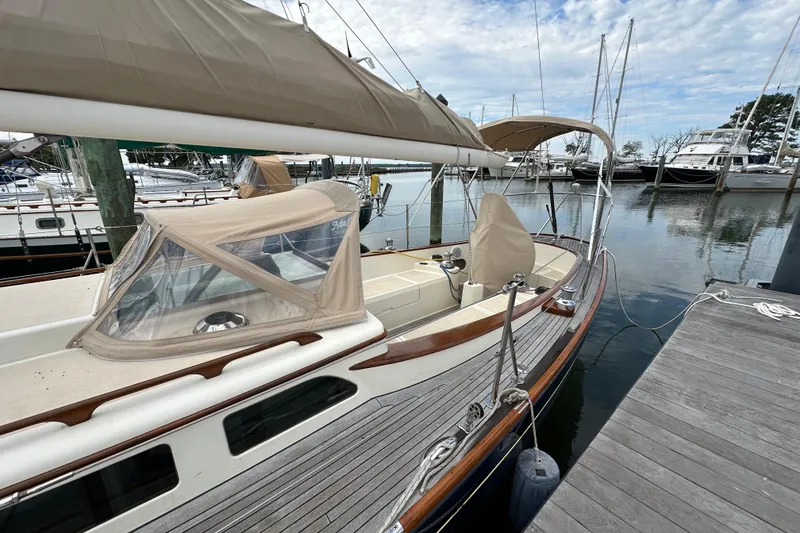 Slide: The Image of Sailboat docked at marina, 2006 Morris M36, featuring tan canopy and wooden deck. - 3