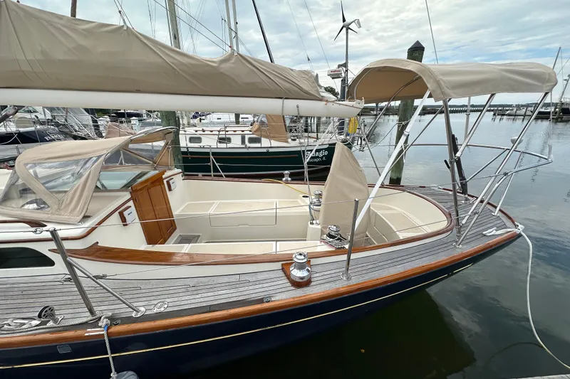 Slide: The Image of Sailboat Morris M36, 2006 model, docked with beige canopy and wooden deck. - 30