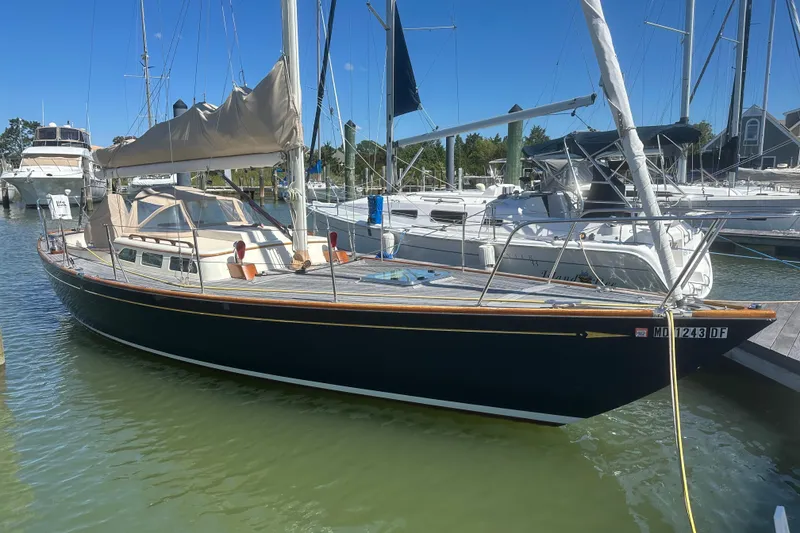 Slide: The Image of 2006 Morris M36 sailboat docked at a marina under clear blue skies. - 6