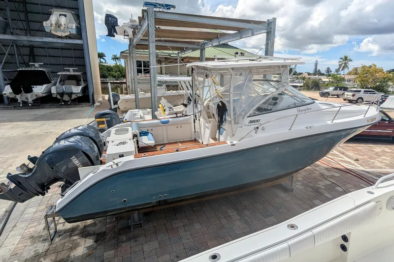 The Image of 2008 Century 3200 Offshore boat with dual Yamaha engines in a marina setting. - 0