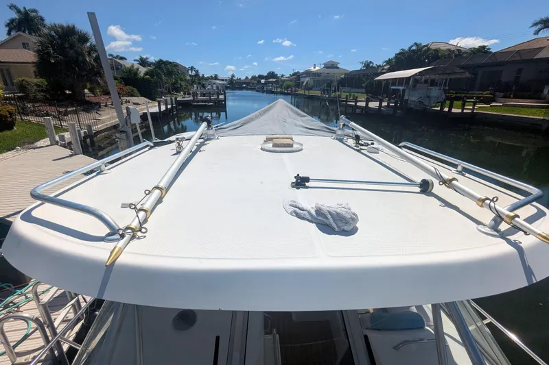 Slide: The Image of 2008 Century 3200 Offshore boat docked in a sunny canal setting. - 11
