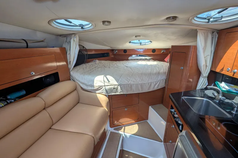 Slide: The Image of Interior of a 2008 Century 3200 Offshore boat with cozy cabin and kitchenette. - 15