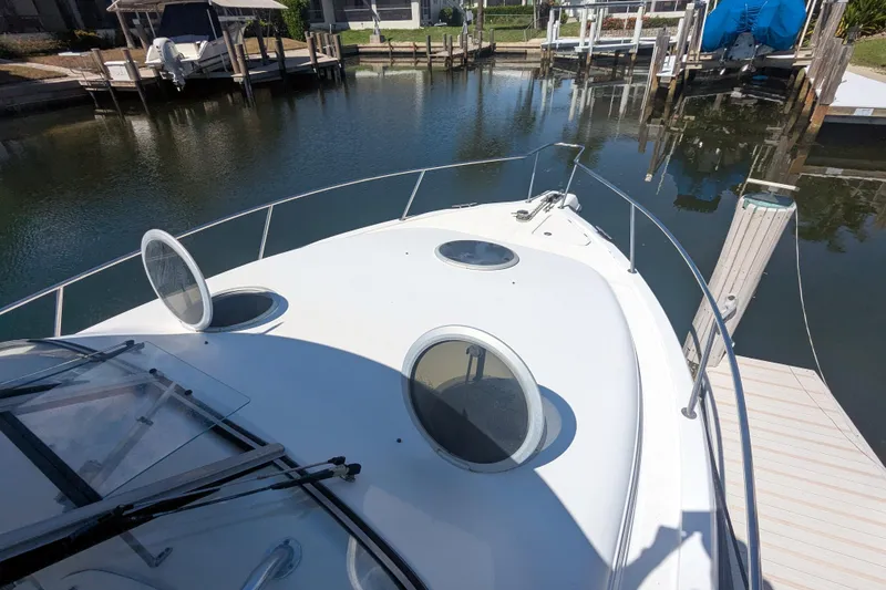 Slide: The Image of 2008 Century 3200 Offshore boat docked at a marina, featuring open hatches. - 17
