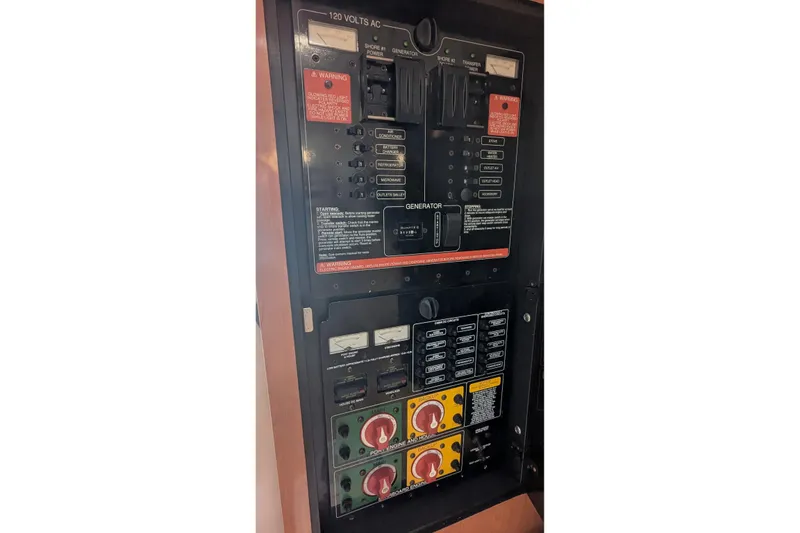 Slide: The Image of Electrical panel of a 2008 Century 3200 Offshore boat, featuring various switches and controls. - 22