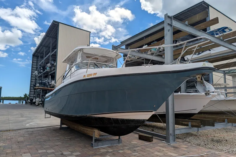 Slide: The Image of 2008 Century 3200 Offshore boat on dry dock under blue sky. - 6
