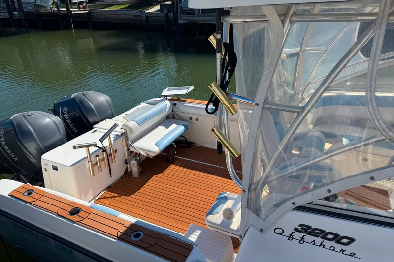 Slide: The Image of 2008 Century 3200 Offshore boat with Yamaha engines, teak deck, and fishing rod holders. - 9