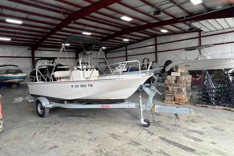 Slide: The Image of 2019 Boston Whaler 170 Montauk boat on trailer in indoor storage facility. - 2
