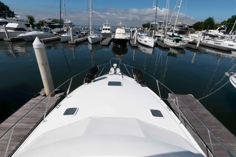 Slide: The Image of Bow view of 2000 Silverton 37 Convertible yacht docked in a marina. - 13