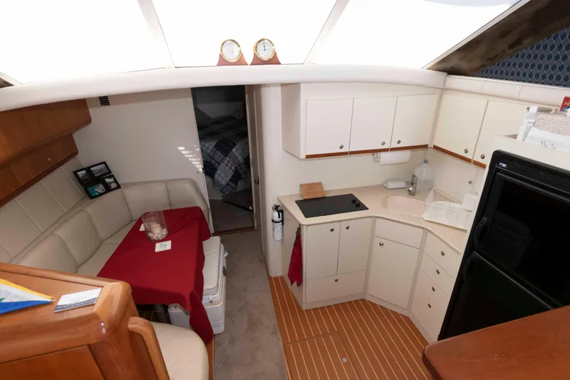 Slide: The Image of Interior of 2000 Silverton 37 Convertible yacht with kitchen and dining area. - 18