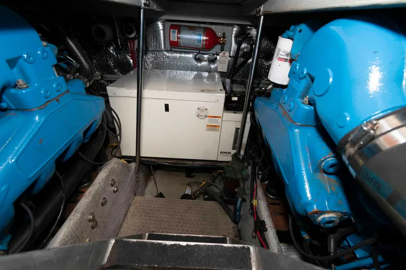 Slide: The Image of Engine room of 2000 Silverton 37 Convertible with blue engines and equipment. - 23