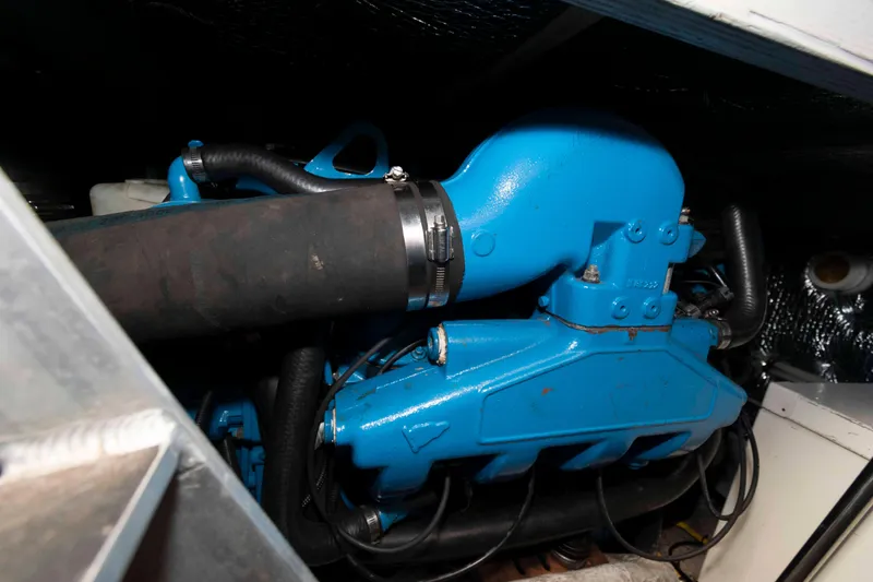 Slide: The Image of Engine compartment of a 2000 Silverton 37 Convertible boat, featuring a blue engine. - 24