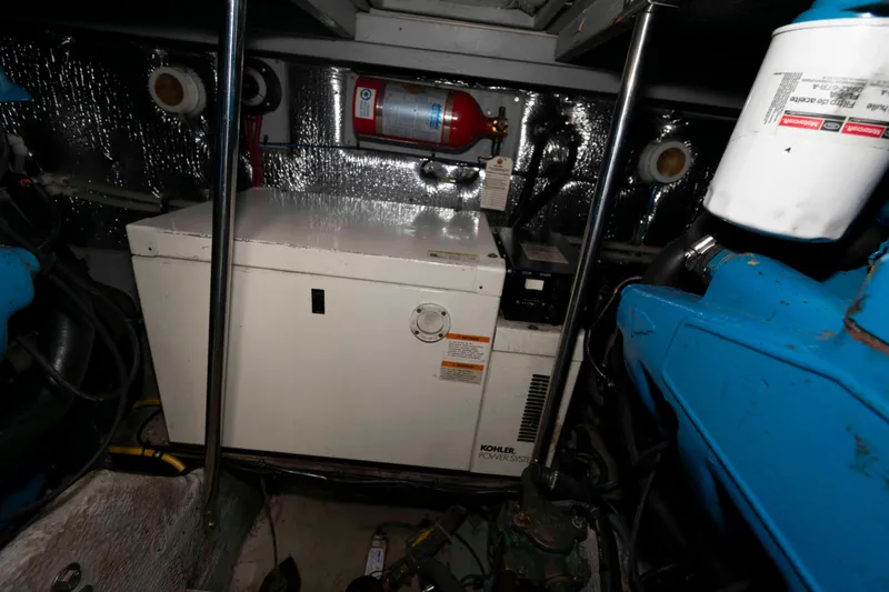Slide: The Image of Engine room of 2000 Silverton 37 Convertible with Kohler power system and fire extinguisher. - 25