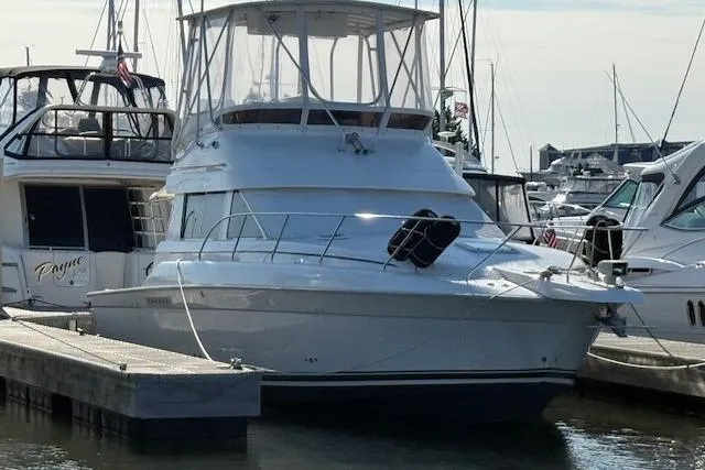Slide: The Image of 2000 Silverton 37 Convertible yacht deck with ladder and sliding glass door. - 5