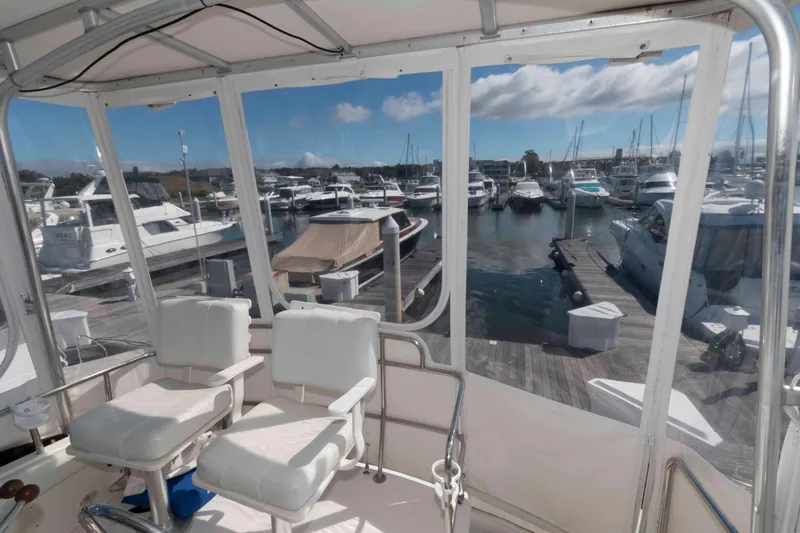 Slide: The Image of Interior view of 2000 Silverton 37 Convertible yacht overlooking marina with boats. - 8