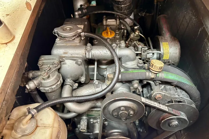 Slide: The Image of Engine compartment of a 2002 Hunter 306 sailboat, showcasing mechanical components. - 10