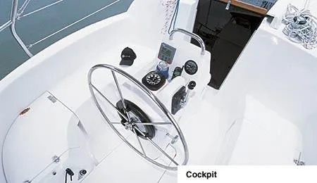 Slide: The Image of 2002 Hunter 306 sailboat docked, featuring sleek design and white hull. - 2