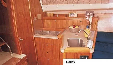 Slide: The Image of 2002 Hunter 306 sailboat on land, surrounded by other boats. - 4