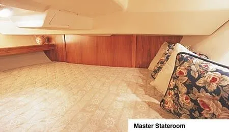 Slide: The Image of Interior of 2002 Hunter 306 sailboat with wood finish and cozy seating area. - 5