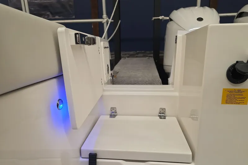 Slide: The Image of 2026 Sailfish 252 CC boat interior with blue LED light and seating area. - 11