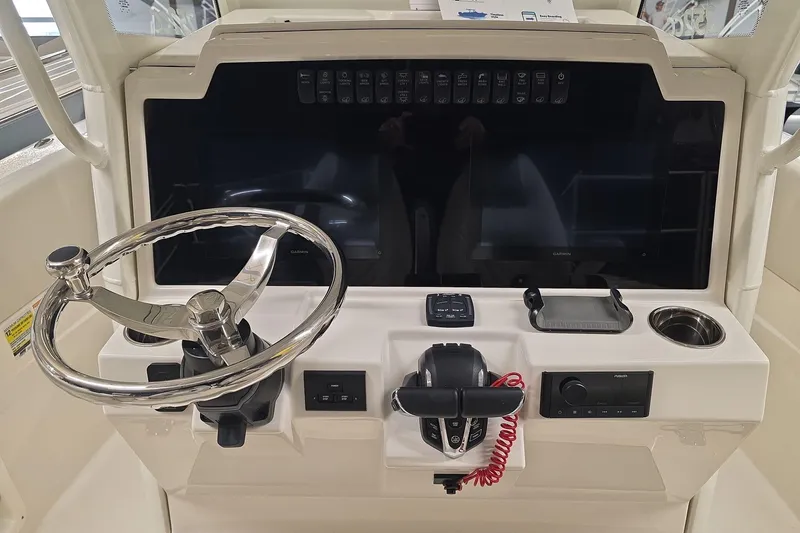 Slide: The Image of 2026 Sailfish 252 CC boat dashboard with steering wheel and control panel. - 13