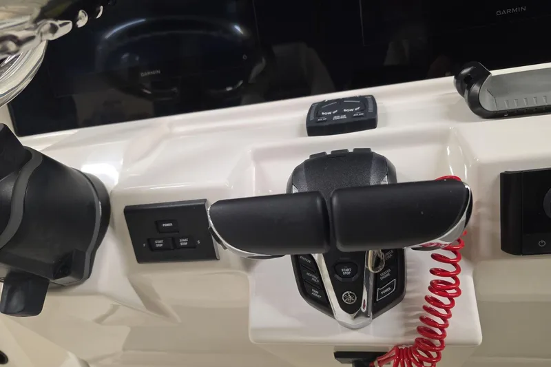 Slide: The Image of Control panel of 2026 Sailfish 252 CC boat with throttle and navigation instruments. - 14