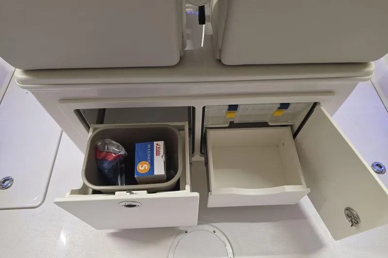Slide: The Image of Storage compartments on a 2026 Sailfish 252 CC boat, featuring organized drawers and containers. - 15