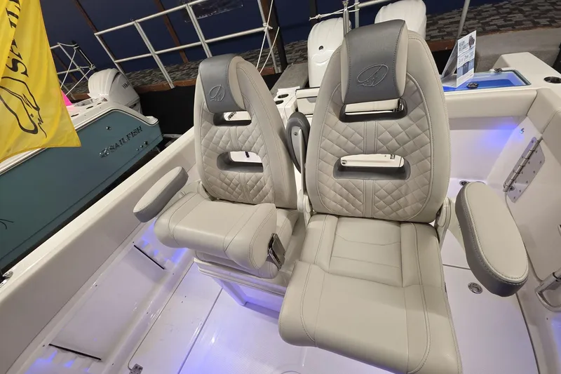 Slide: The Image of Luxury seating on 2026 Sailfish 252 CC boat, featuring quilted design and armrests. - 16