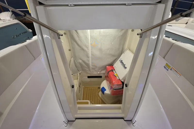 Slide: The Image of 2026 Sailfish 252 CC boat interior with storage and seating area. - 18