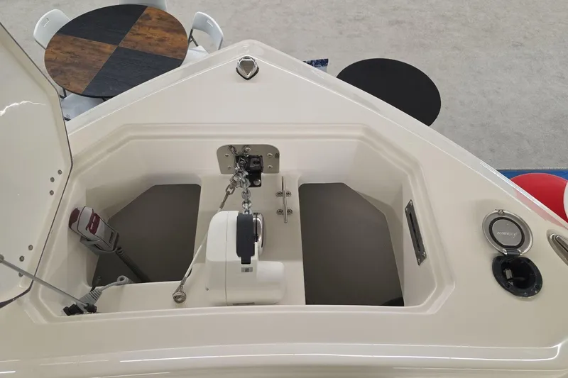 Slide: The Image of 2026 Sailfish 252 CC boat anchor compartment with chain and winch system. - 5