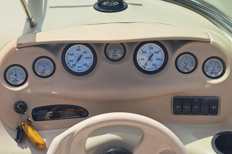 Slide: The Image of Dashboard of a 1998 Sea Ray 190 Cuddy Cabin boat with gauges and controls. - 3