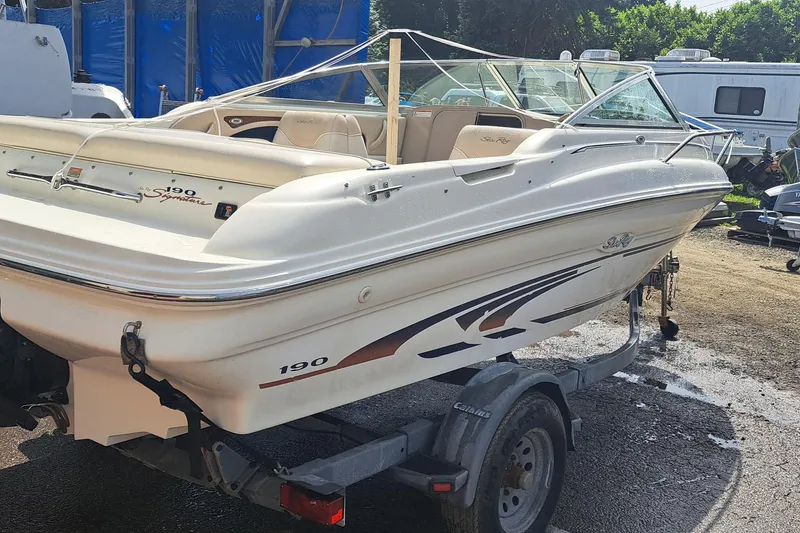 Slide: The Image of 1998 Sea Ray 190 Cuddy Cabin boat on trailer, parked outdoors. - 5