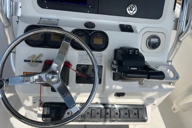 Slide: The Image of Steering console of a 2004 Century 2600 CC boat with gauges and controls. - 10