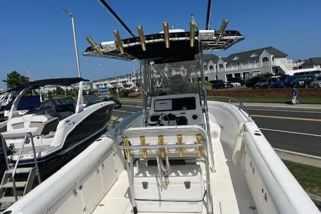 Slide: The Image of 2004 Century 2600 CC boat with center console, docked near waterfront buildings. - 13