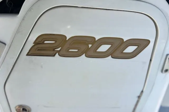 Slide: The Image of Close-up of 2004 Century 2600 CC boat emblem on white surface. - 14