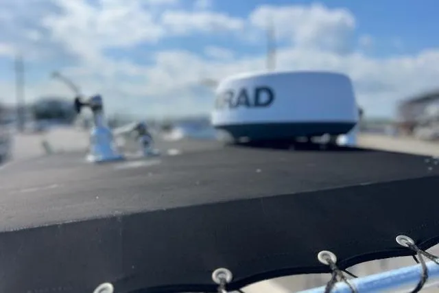 Slide: The Image of 2004 Century 2600 CC boat with radar equipment under a cloudy sky. - 17