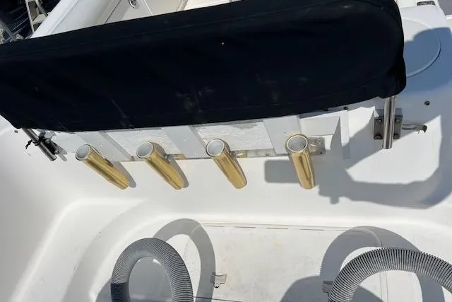 Slide: The Image of 2004 Century 2600 CC boat interior with rod holders and seating. - 18