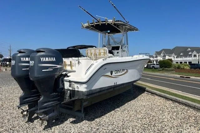 Slide: The Image of 2004 Century 2600 CC boat with dual Yamaha engines on gravel lot. - 2