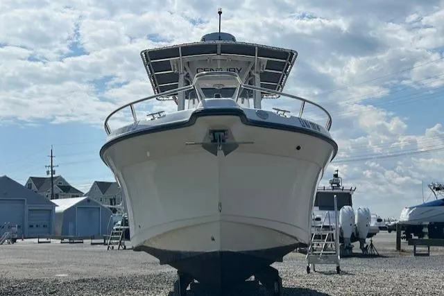 Slide: The Image of 2004 Century 2600 CC boat on dry dock under a cloudy sky. - 3