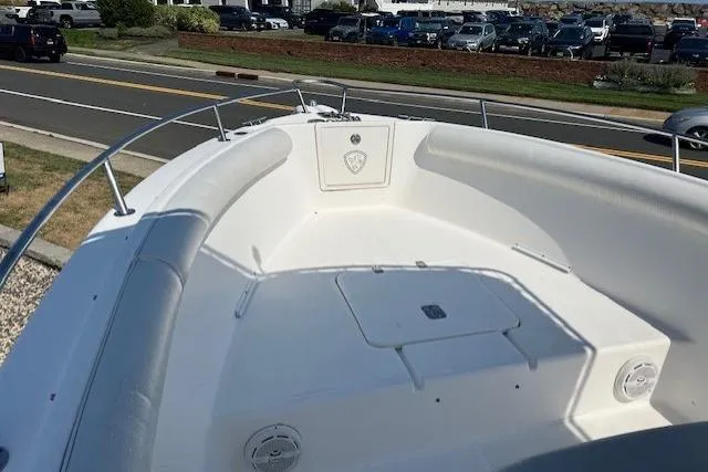 Slide: The Image of 2004 Century 2600 CC boat with spacious deck, parked near a road. - 6