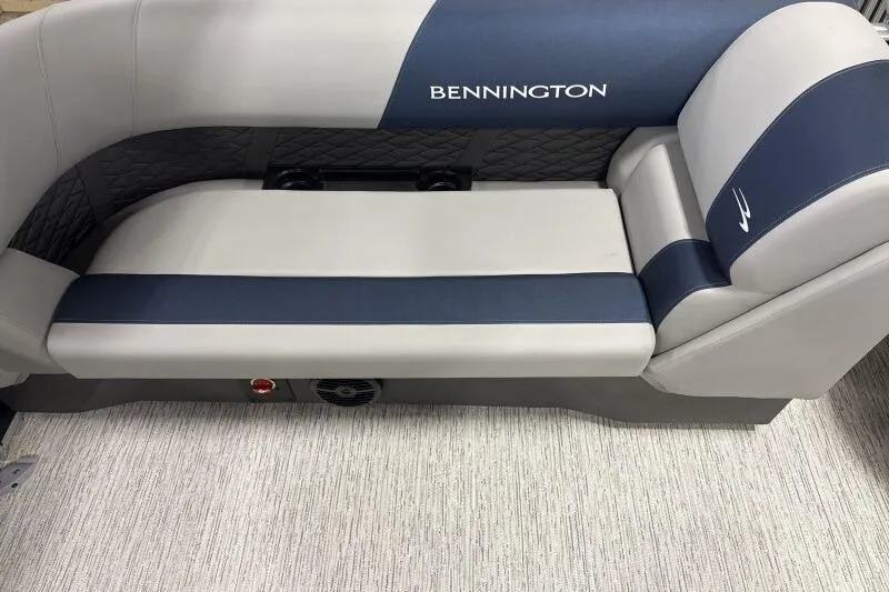 Slide: The Image of 2026 Bennington 23 SSRSF pontoon boat with blue cover in a warehouse setting. - 13