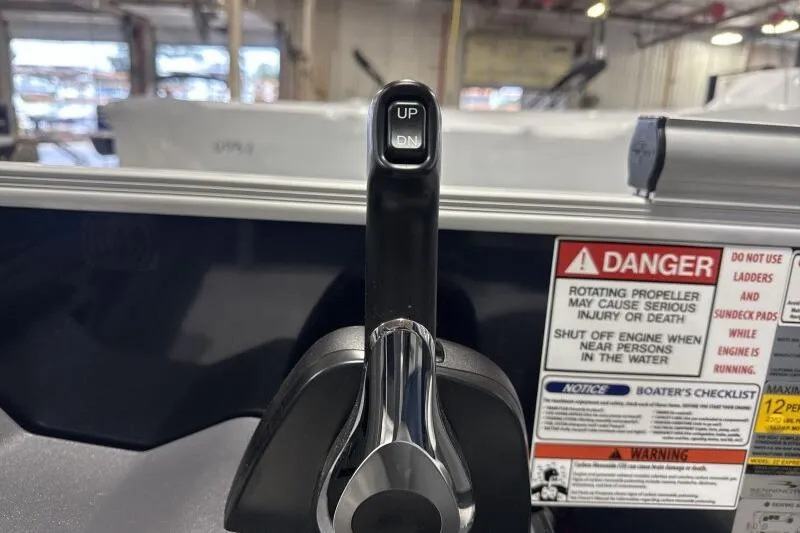 Slide: The Image of Throttle control lever on a 2026 Bennington 23 SSRSF boat with safety warnings. - 22