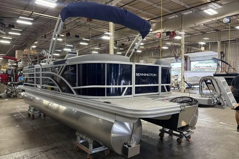 Slide: The Image of 2026 Bennington 23 SSRSF pontoon boat in a factory setting. - 5