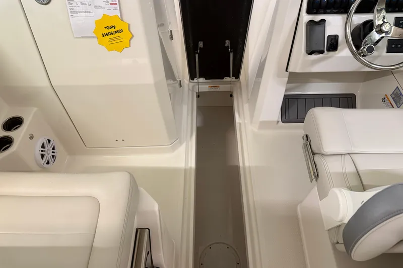 Slide: The Image of 2026 Sailfish 276 DC boat interior with steering wheel and seating area. - 12