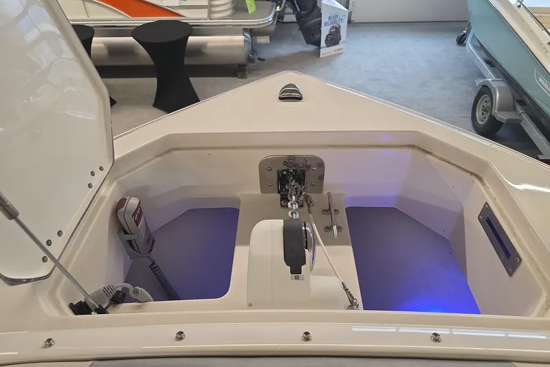 Slide: The Image of 2026 Sailfish 276 DC boat anchor compartment with blue lighting and equipment. - 24