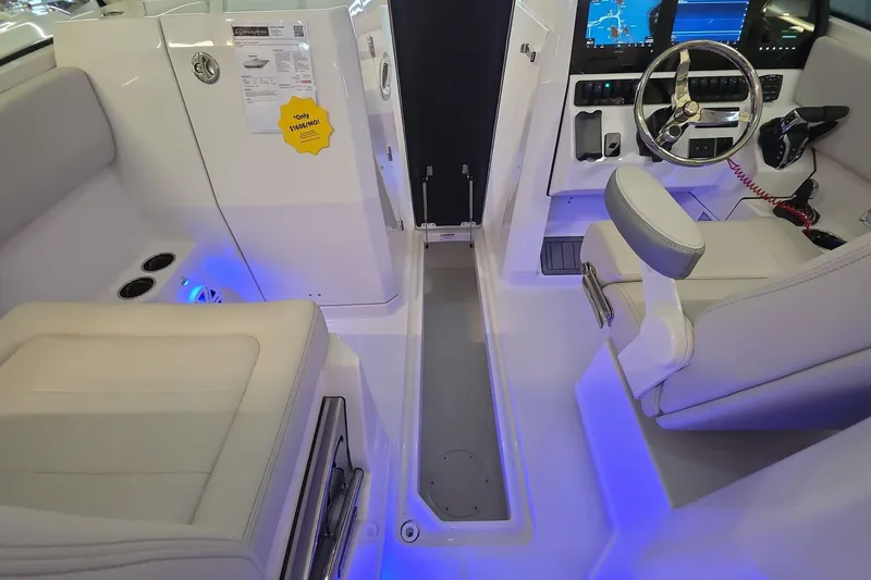 Slide: The Image of 2026 Sailfish 276 DC boat interior with modern dashboard and blue ambient lighting. - 26