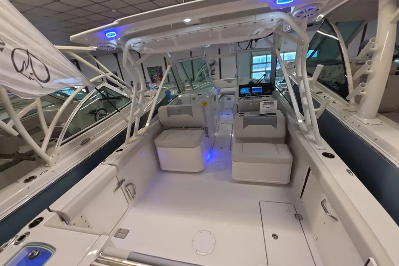Slide: The Image of 2026 Sailfish 276 DC boat interior with seating, modern design, and blue LED lighting. - 30