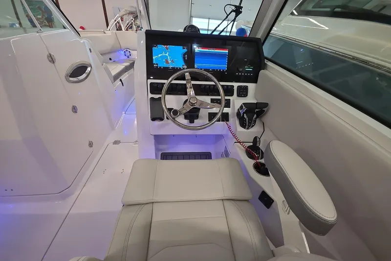 Slide: The Image of 2026 Sailfish 276 DC boat cockpit with modern steering and navigation displays. - 31